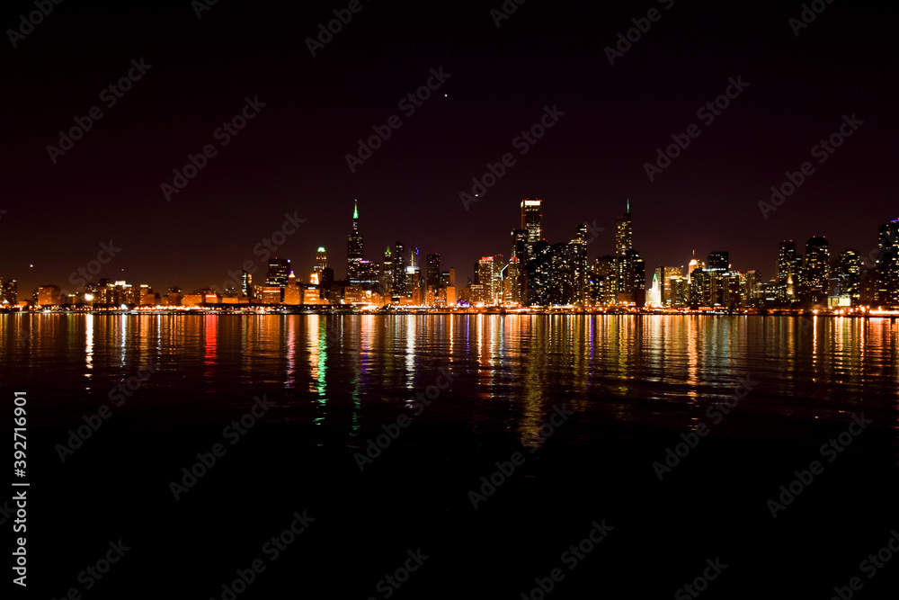 Chicago city skyline reflecting off the water at night
