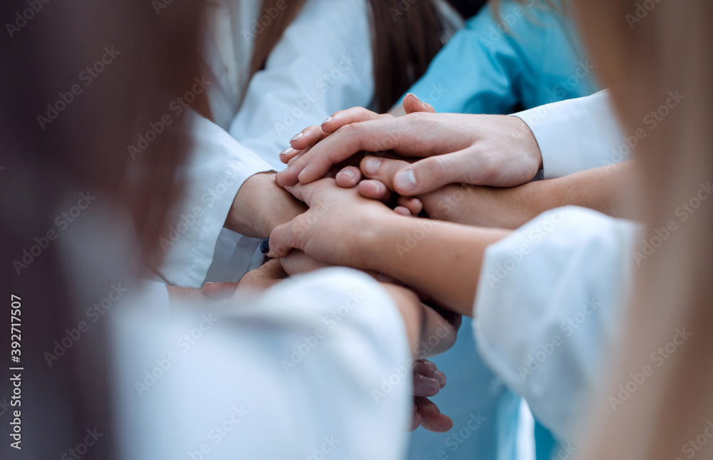 top view. a group of smiling doctors pointing at you.