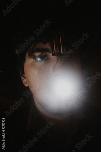 Glowing person with electric in the darkness, an abstract art portrait, tongue to confess photo