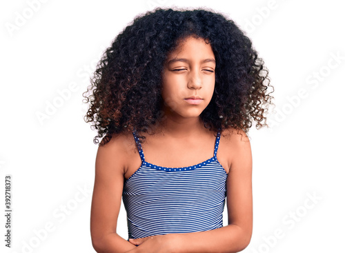 African american child with curly hair wearing swimwear with hand on stomach because indigestion, painful illness feeling unwell. ache concept.