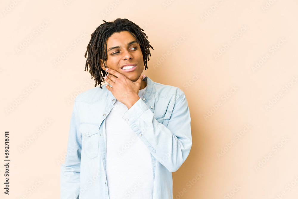 Young african american rasta man touching back of head, thinking and making a choice. Young african american rasta man touching back of head, thinking and making a choice.