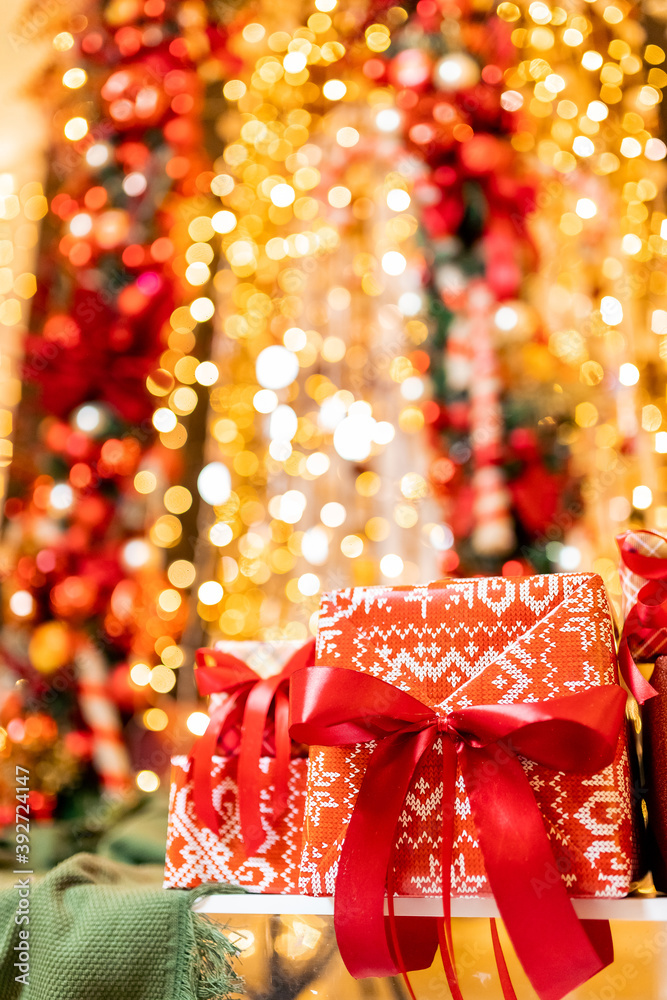 Christmas gift boxes with red ribbon on bokeh blur lights and illumination background