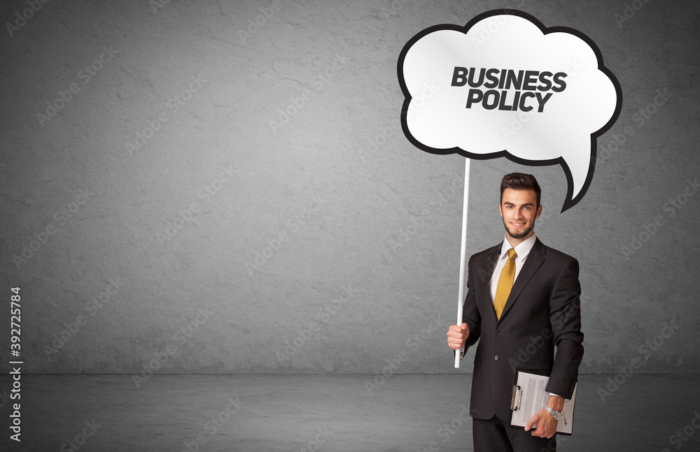 Young business person in casual holding road sign with BUSINESS POLICY inscription, new business idea concept Young business person in casual holding road sign with BUSINESS POLICY inscription, new business idea concept