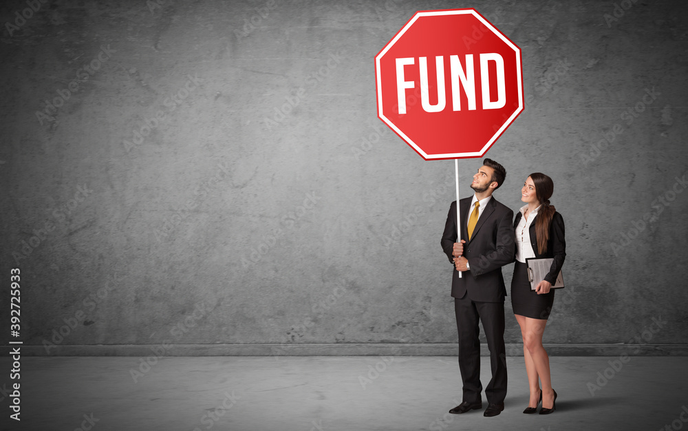 Young business person holding road sign with FUND inscription, new rules concept Young business person holding road sign with FUND inscription, new rules concept