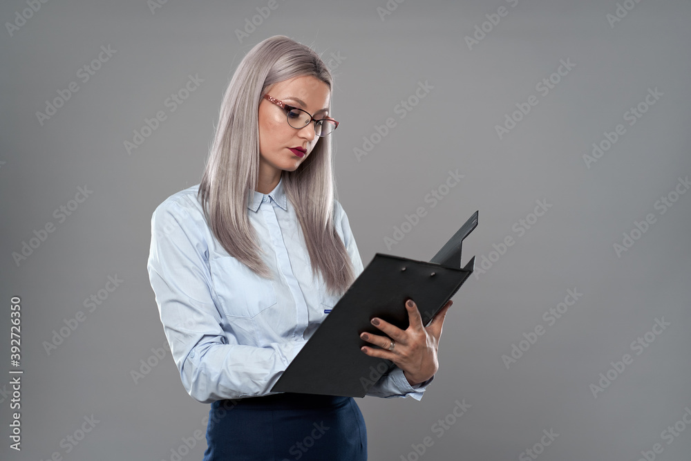 Secretary, teacher or businesswoman holding a clipboard Secretary, teacher or businesswoman holding a clipboard