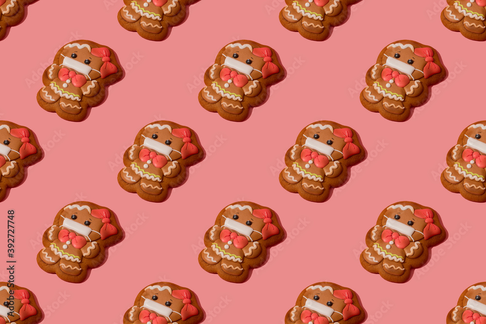 Christmas gingerbread girl in medicine mask on the rose background Christmas gingerbread girl in medicine mask on the rose background