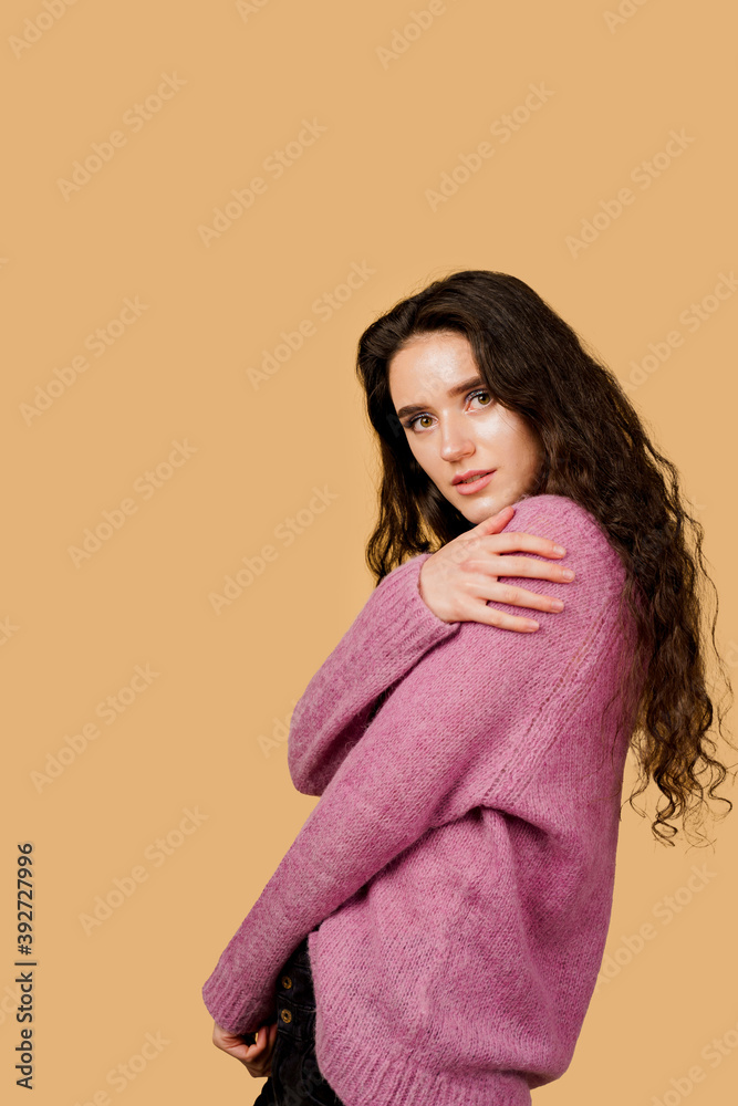 Fashion model posing in studio isoleted on yellow background. Lifestyle of pretty girl. Happy lady weared pink pullover. Fashion model posing in studio isoleted on yellow background. Lifestyle of pretty girl. Happy lady weared pink pullover.