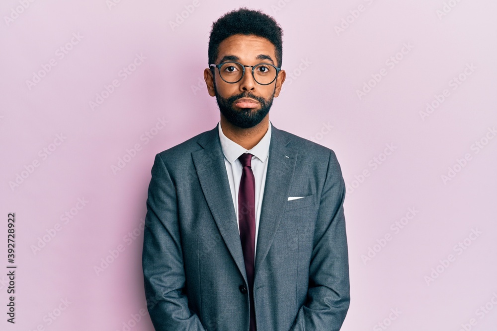 Handsome young hispanic man wearing business suit and tie approving doing positive gesture with hand, thumbs up smiling and happy for success. winner gesture. Handsome young hispanic man wearing business suit and tie approving doing positive gesture with hand, thumbs up smiling and happy for success. winner gesture.