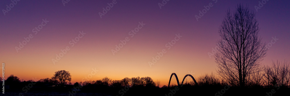 Panorama of landscape silhouette with bridge of munsterland at dusk