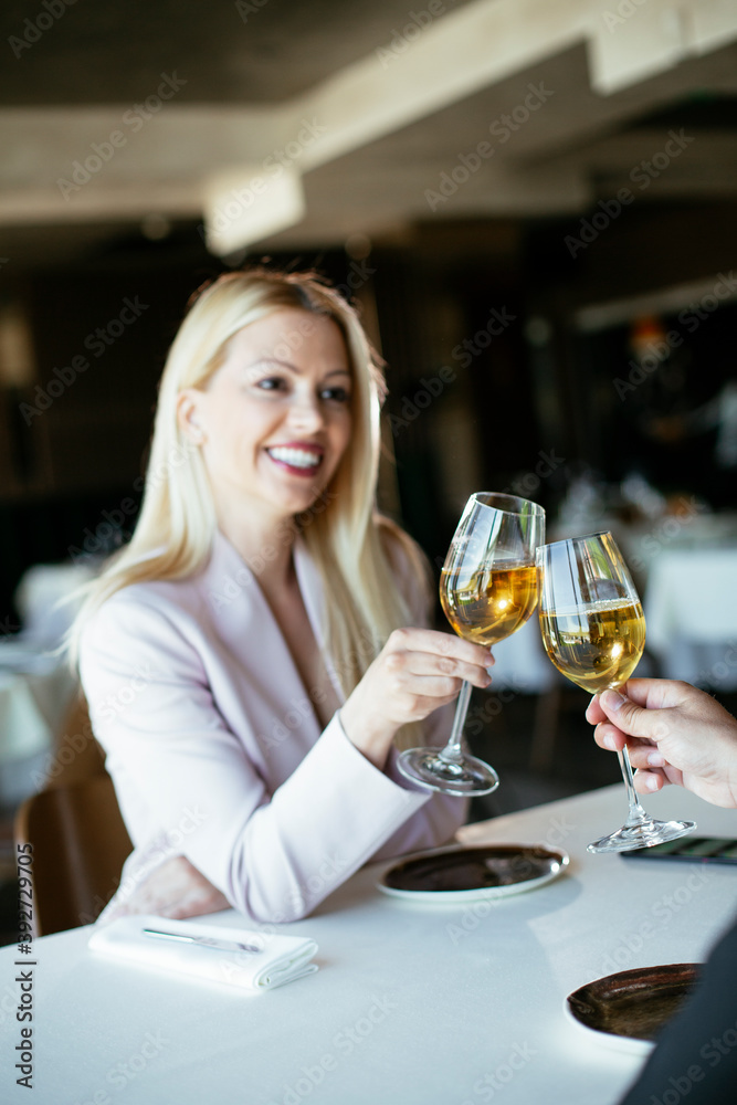 Beautiful businesswoman drinking wine. Businesswoman enjoying in the restaurant