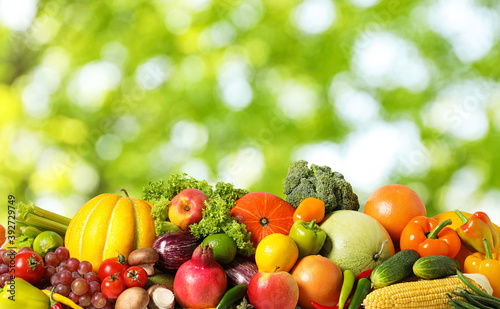 Fototapeta Naklejka Na Ścianę i Meble -  Assortment of fresh organic vegetables and fruits on blurred green background