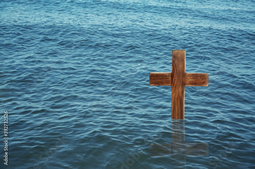 Fotobehang Wooden cross in river for religious ritual known as baptism