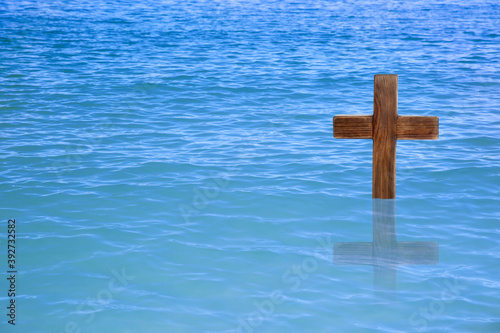 Wooden cross in river for religious ritual known as baptism Fototapeta