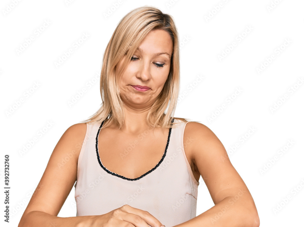 Middle age caucasian woman wearing casual clothes checking the time on wrist watch, relaxed and confident Middle age caucasian woman wearing casual clothes checking the time on wrist watch, relaxed and confident