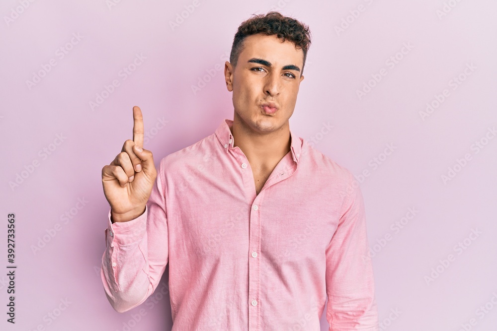 Handsome young man pointing up with fingers depressed and worry for distress, crying angry and afraid. sad expression. Handsome young man pointing up with fingers depressed and worry for distress, crying angry and afraid. sad expression.