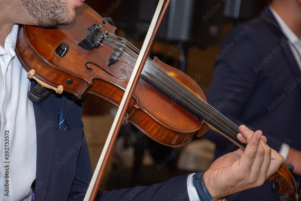 Close-up view of hands playing the violin Close-up view of hands playing the violin