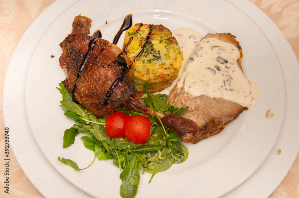 neck with mushroom sauce, duck confit, potatoes with broccoli and valerian with tomatoes neck with mushroom sauce, duck confit, potatoes with broccoli and valerian with tomatoes