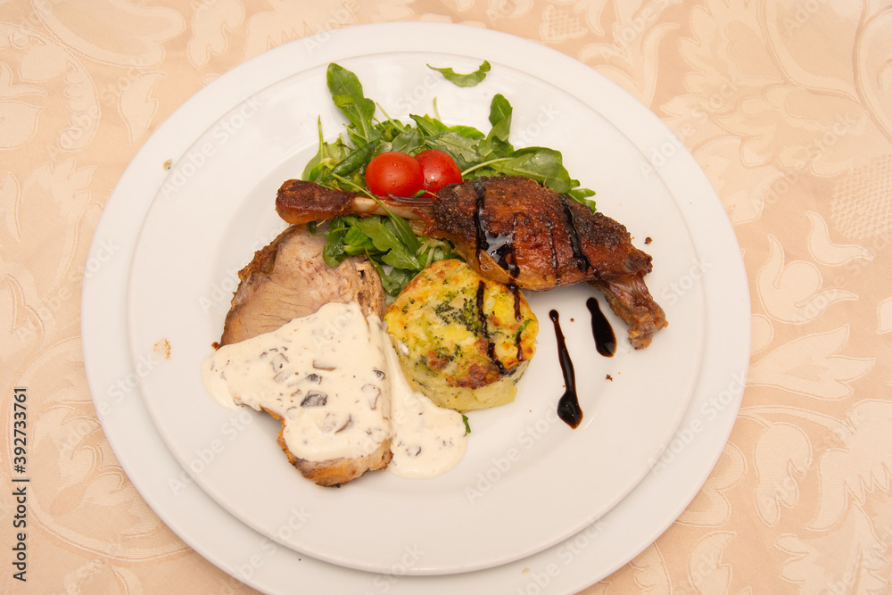 neck with mushroom sauce, duck confit, potatoes with broccoli and valerian with tomatoes neck with mushroom sauce, duck confit, potatoes with broccoli and valerian with tomatoes