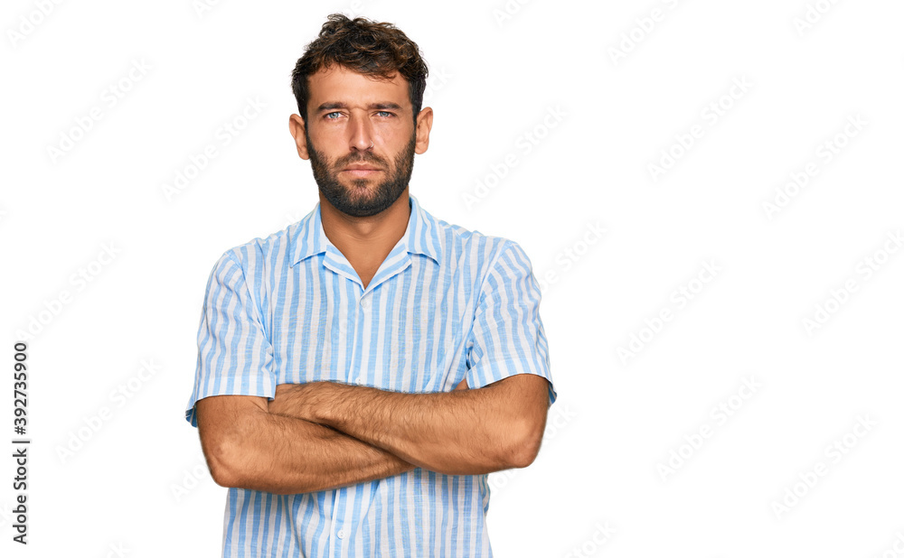 Fototapeta premium Handsome young man with beard wearing casual fresh shirt skeptic and nervous, disapproving expression on face with crossed arms. negative person.