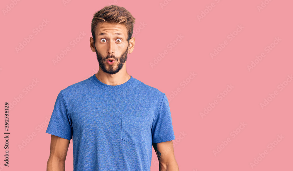 Handsome blond man with beard wearing casual clothes scared and amazed with open mouth for surprise, disbelief face