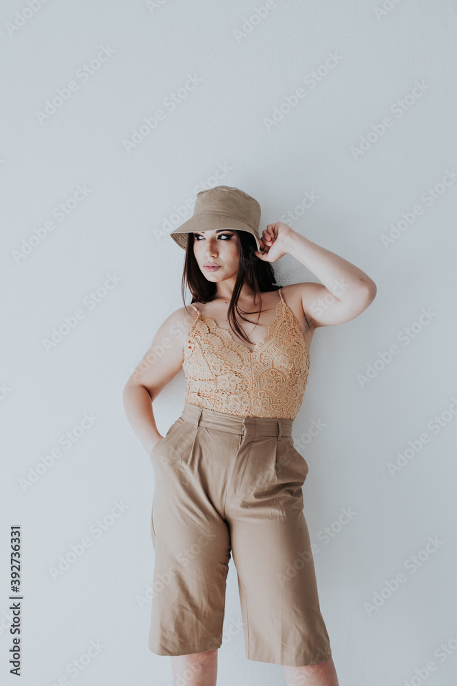 brunette woman of oriental appearance in beige clothes brunette woman of oriental appearance in beige clothes