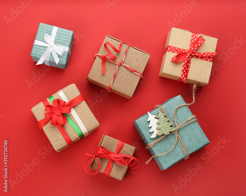 Christmas gift boxes on red background, flat lay