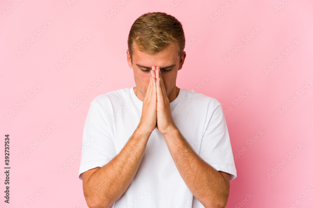 Young caucasian handsome man praying, showing devotion, religious person looking for divine inspiration. Young caucasian handsome man praying, showing devotion, religious person looking for divine inspiration.
