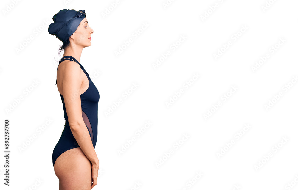 Young beautiful hispanic woman wearing swimwear and swimmer glasses looking to side, relax profile pose with natural face with confident smile. - obrazy, fototapety, plakaty 