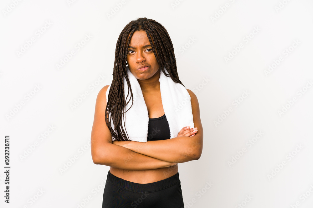 Young african american sport woman isolated frowning face in displeasure, keeps arms folded.