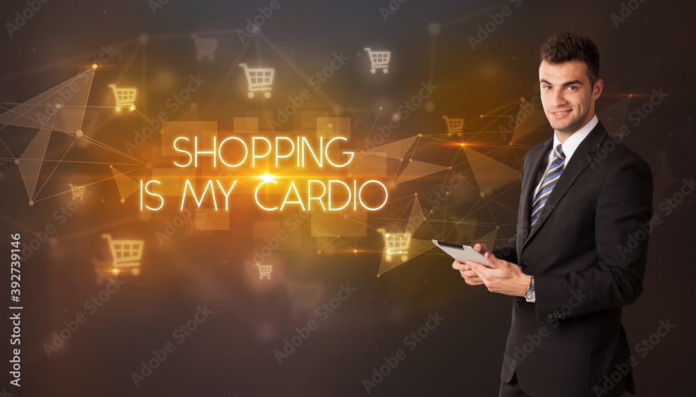 Businessman with shopping cart icons and SHOPPING IS MY CARDIO inscription, online shopping concept Businessman with shopping cart icons and SHOPPING IS MY CARDIO inscription, online shopping concept