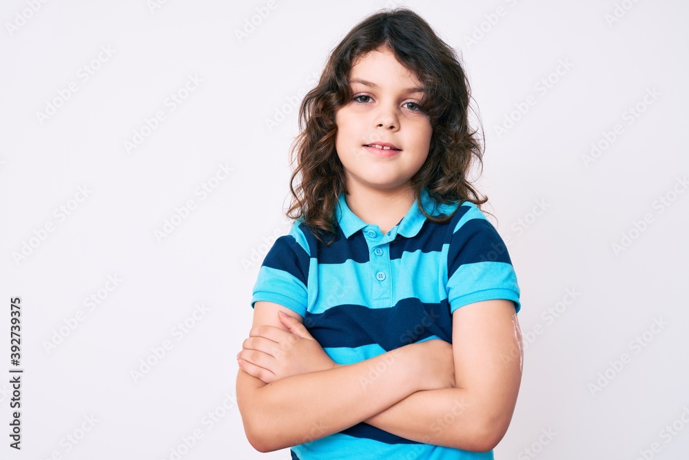 Cute hispanic child with long hair wearing casual clothes happy face smiling with crossed arms looking at the camera. positive person. Cute hispanic child with long hair wearing casual clothes happy face smiling with crossed arms looking at the camera. positive person.