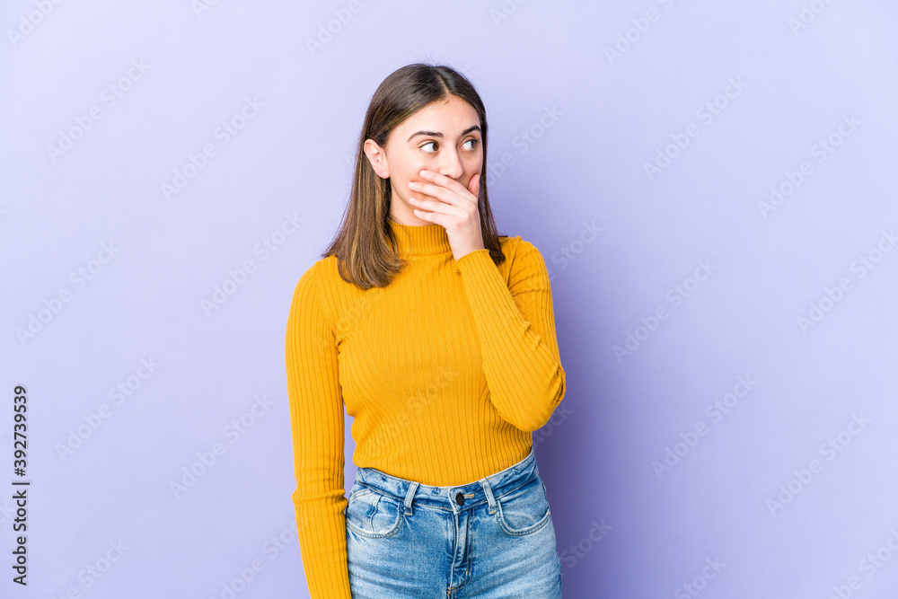 Young caucasian woman thoughtful looking to a copy space covering mouth with hand. Young caucasian woman thoughtful looking to a copy space covering mouth with hand.