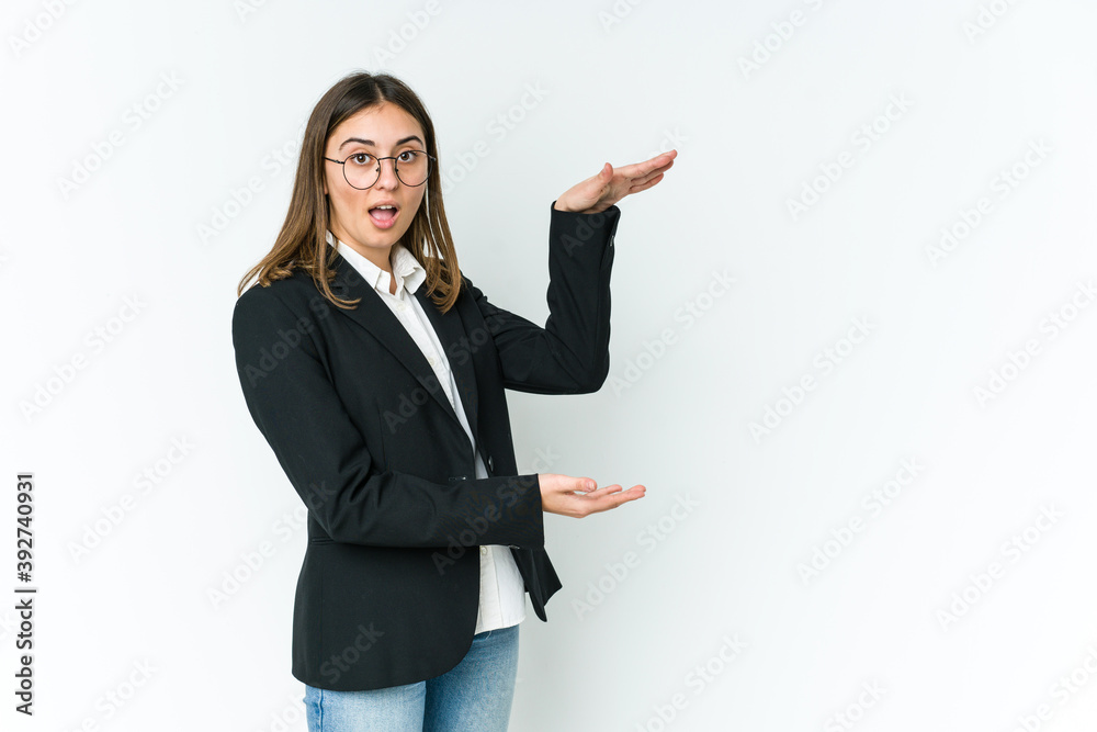Young caucasian business woman shocked and amazed holding a copy space between hands. Young caucasian business woman shocked and amazed holding a copy space between hands.