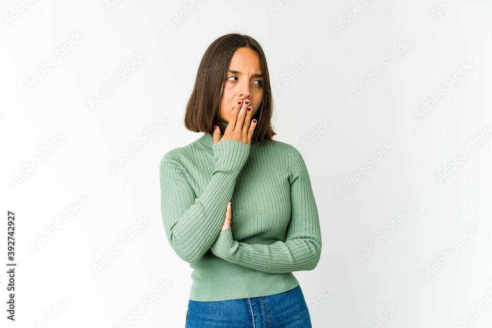 Young mixed race woman yawning showing a tired gesture covering mouth with hand. Young mixed race woman yawning showing a tired gesture covering mouth with hand.