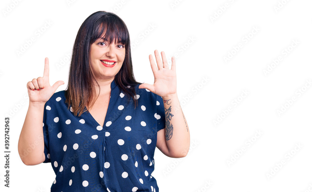 Young plus size woman wearing casual clothes showing and pointing up with fingers number seven while smiling confident and happy. Young plus size woman wearing casual clothes showing and pointing up with fingers number seven while smiling confident and happy.