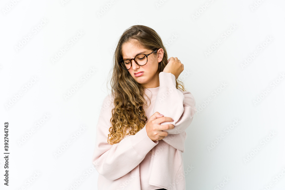 Young caucasian woman massaging elbow, suffering after a bad movement. Young caucasian woman massaging elbow, suffering after a bad movement.