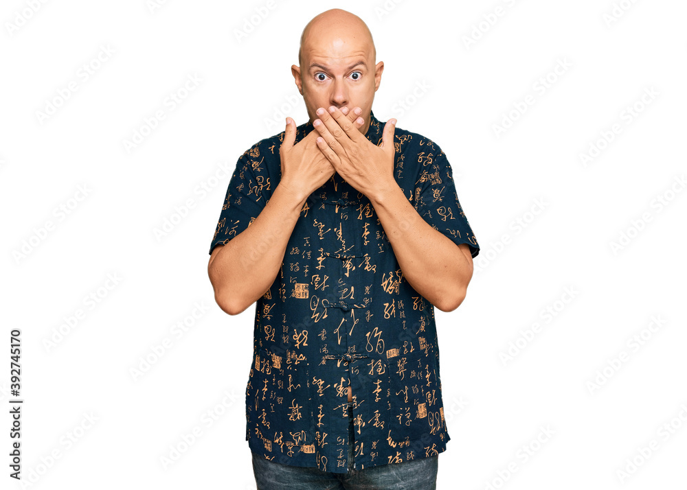 Middle age bald man wearing casual clothes shocked covering mouth with hands for mistake. secret concept. Middle age bald man wearing casual clothes shocked covering mouth with hands for mistake. secret concept.