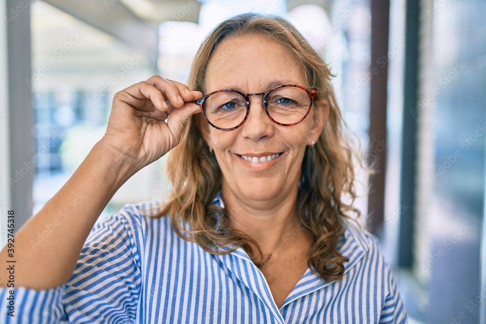 Middle age caucasian woman smiling happy standing at the city. Middle age caucasian woman smiling happy standing at the city.