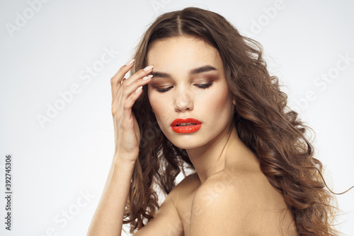 Beautiful woman with drawn swords bright makeup glamor close-up light background