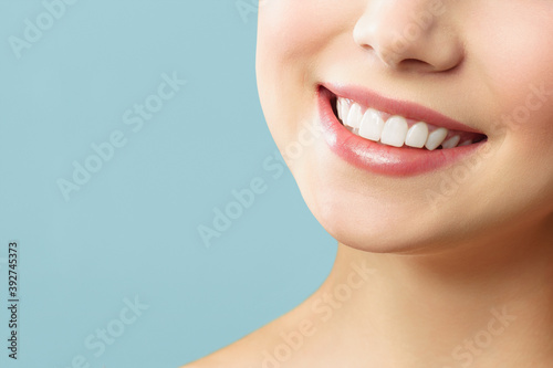 Perfect healthy teeth smile of a young woman. Teeth whitening. Stomatology concept.