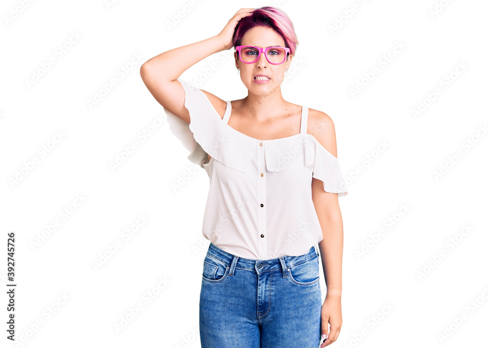 Young beautiful woman with pink hair wearing casual clothes and glasses confuse and wonder about question. uncertain with doubt, thinking with hand on head. pensive concept. Young beautiful woman with pink hair wearing casual clothes and glasses confuse and wonder about question. uncertain with doubt, thinking with hand on head. pensive concept.