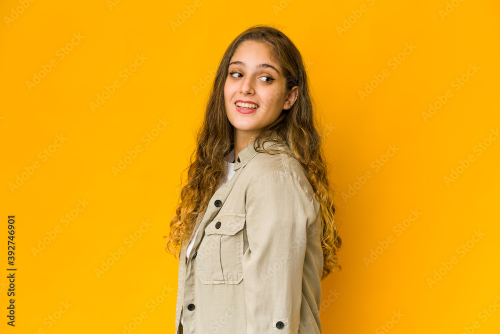 Young caucasian woman looks aside smiling, cheerful and pleasant. Young caucasian woman looks aside smiling, cheerful and pleasant.