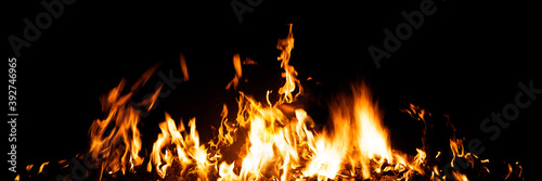 Fotografie Burning red hot sparks rise from large fire in the night