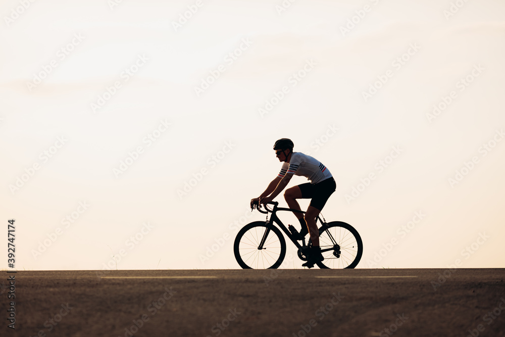 Side view of man in sport clothing riding on road