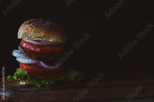 Hamburger in dark food mood with copy space