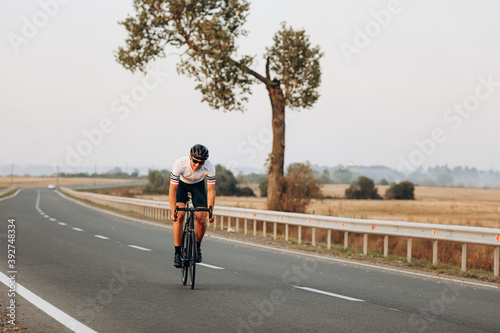 Smiling cyclist enjoying sport activity on bike outdoors