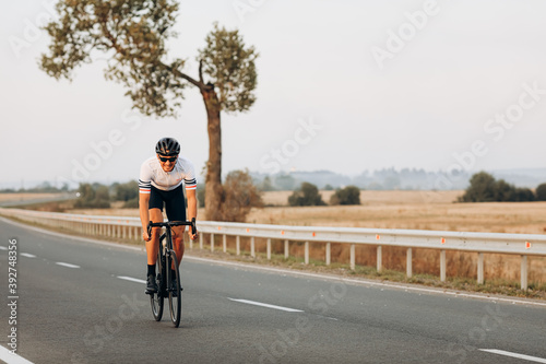 Wallpaper Mural Cheerful man cycling on paved road among countryside Torontodigital.ca
