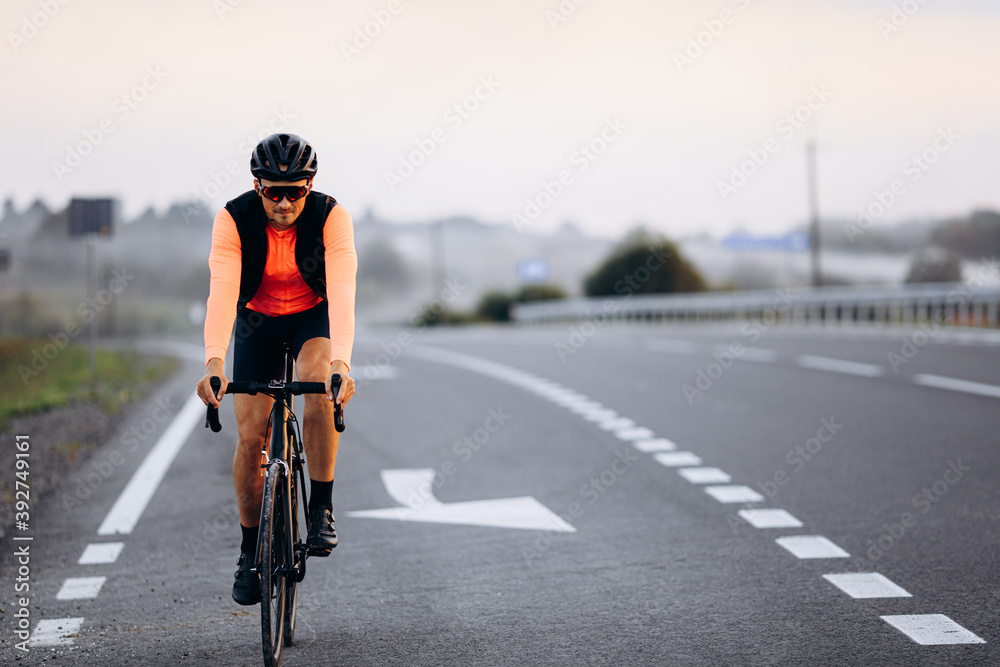 Fototapeta premium Professional cyclist in activewear riding outdoors