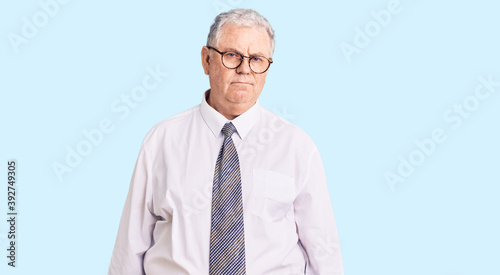 Senior grey-haired man wearing business clothes depressed and worry for distress, crying angry and afraid. sad expression.