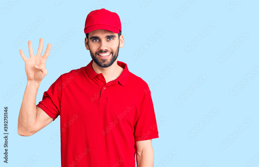 Young handsome man with beard wearing delivery uniform showing and pointing up with fingers number four while smiling confident and happy.